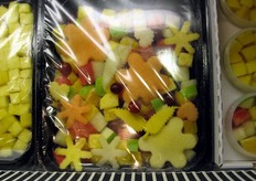 Dettaglio di confezione di frutta tagliata in varie forme.